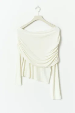 Sloped shoulder cape top
